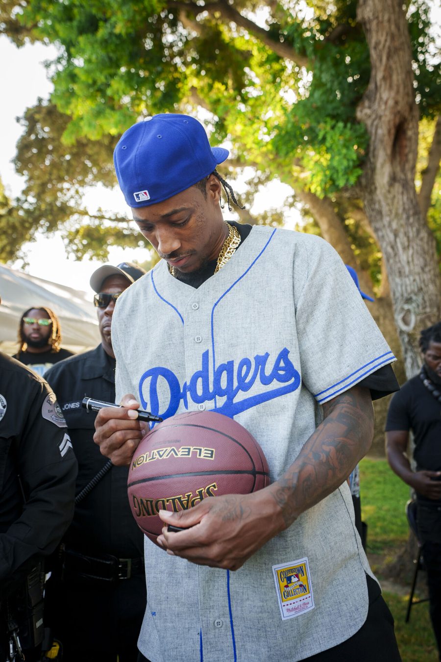 DeMar DeRozan signing a basketball at Compton Fest