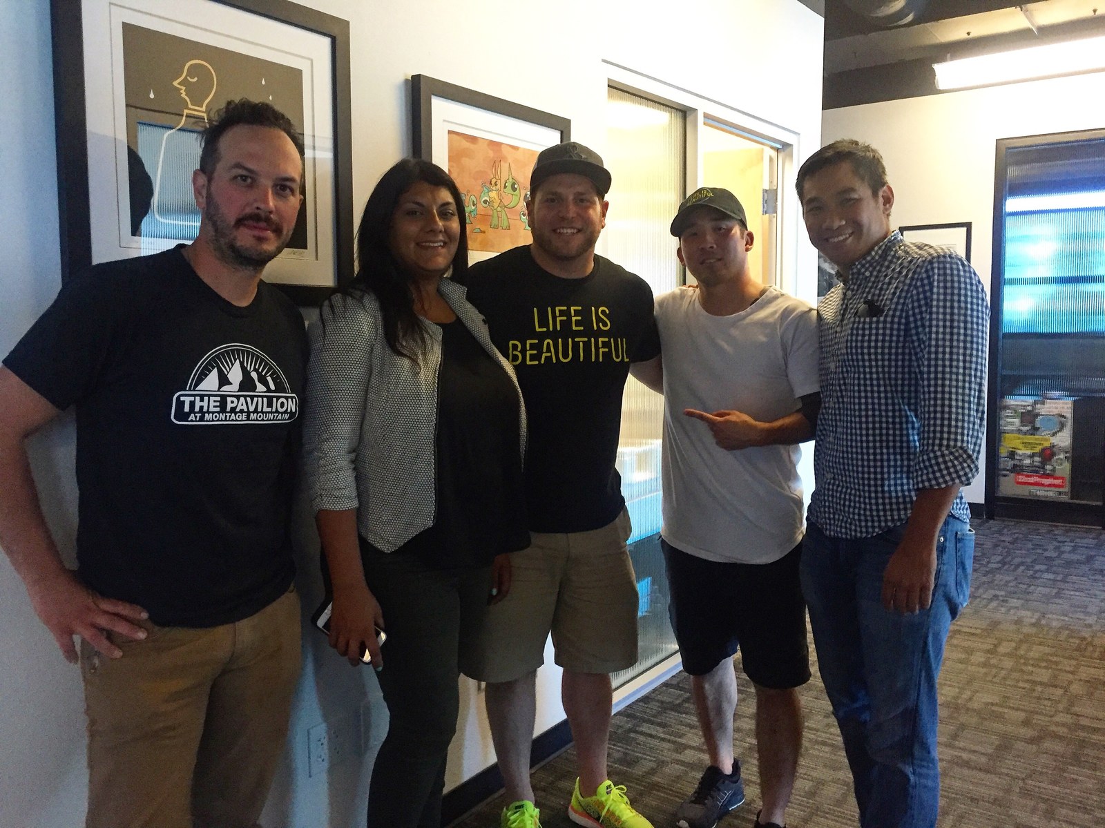 Tim Hirata with five Life is Beautiful and venue staff in an office