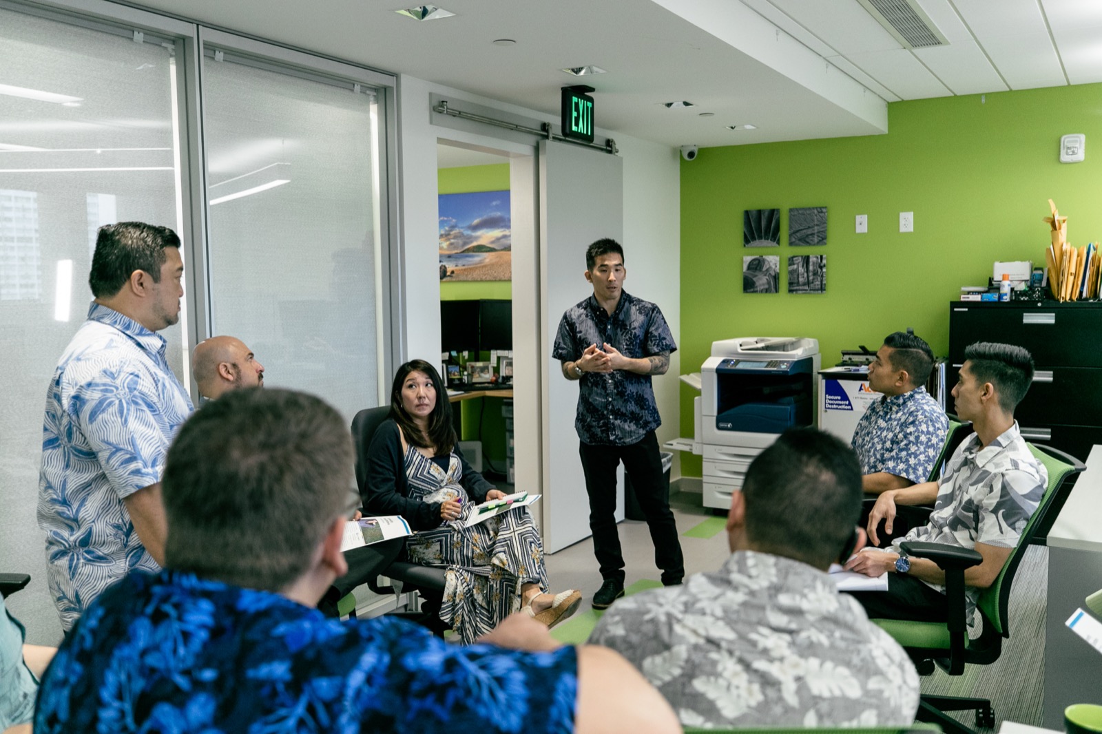 Tim Hirata leading a team workshop in an office